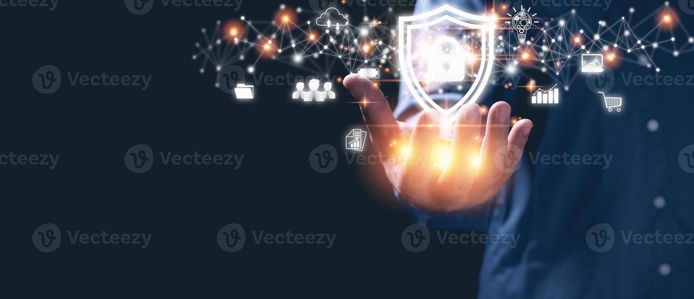 Businessman holding shield with padlock icon protection personal data in a virtual world on hands. Cybersecurity protection, technology, insurance business, business network security concept. photo