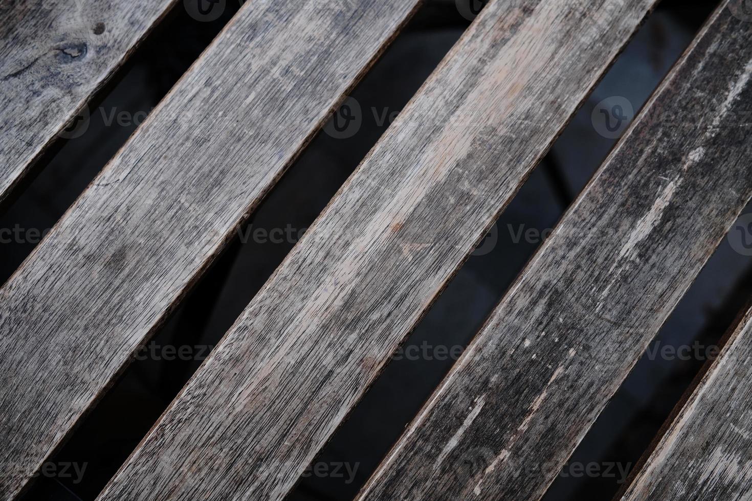 Close up photo of outdoor cafe table. Brown wood planks of different textures, table top view.