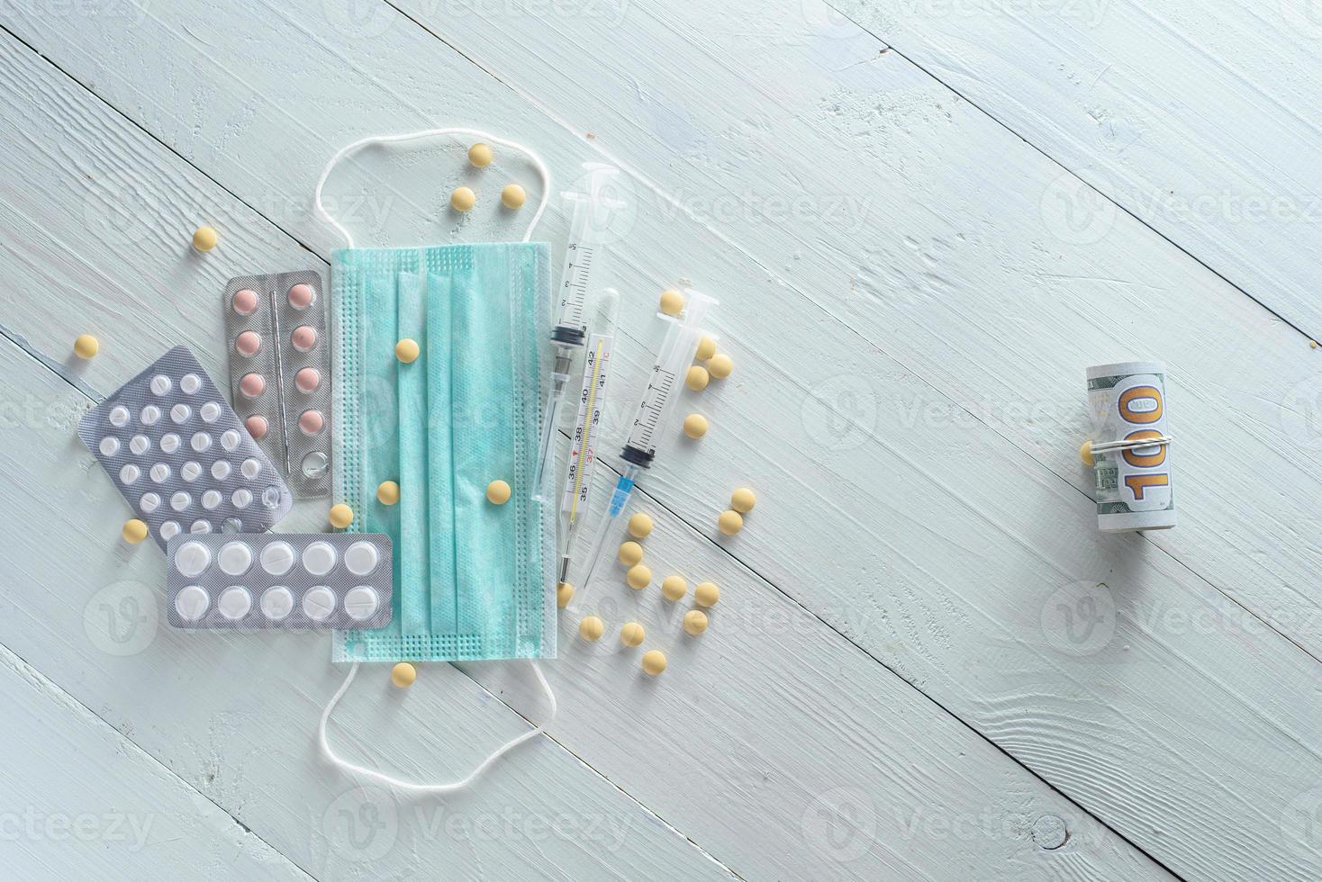 Medical mask, pills and medicines. Shot from above on a white background. photo