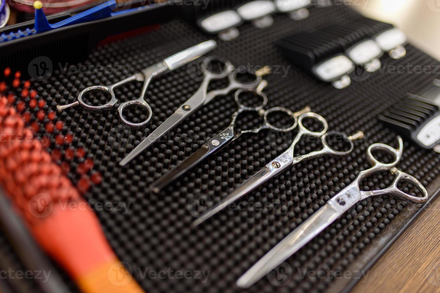 Scissors on a stand in a barbershop. Close-up shot. Place for a logo. photo