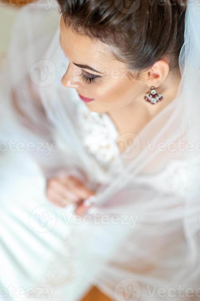 Close-up portrait of a young beautiful bride. Taken from the top view. photo