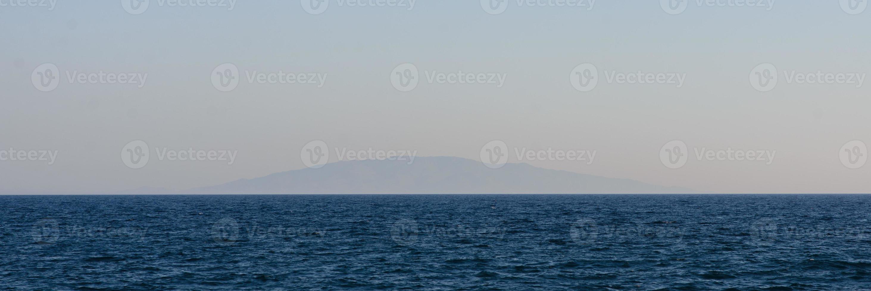 Lonely volcanic island far above the water. photo