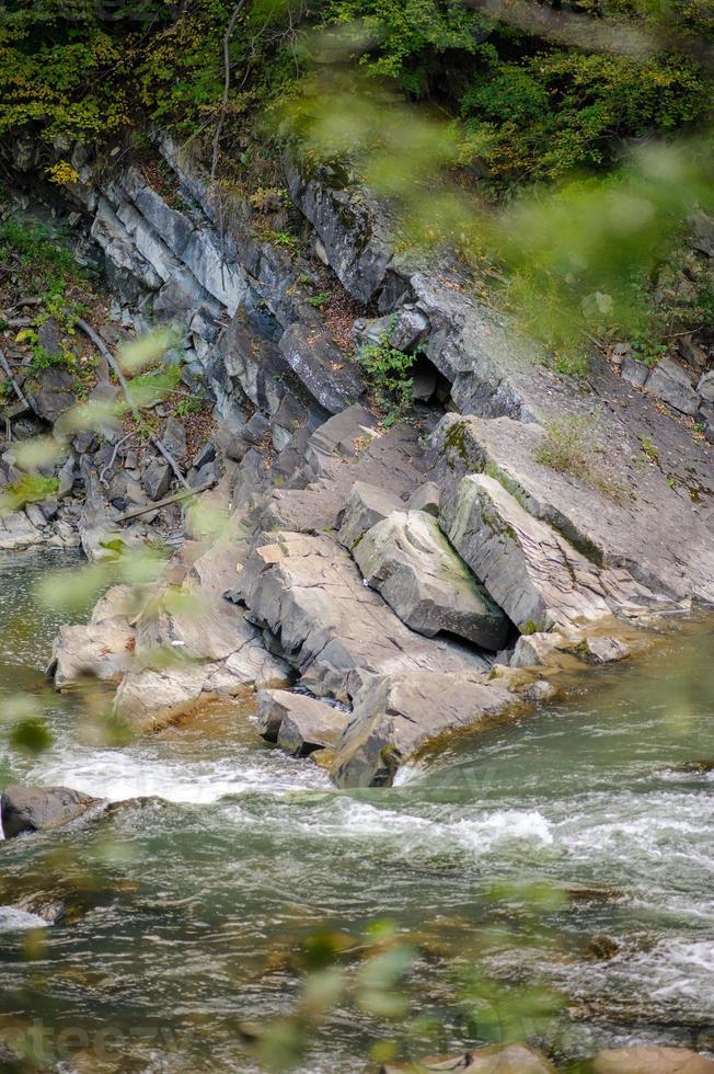 Collision layers of the mainland plates that formed the mountains. Near the river flows photo