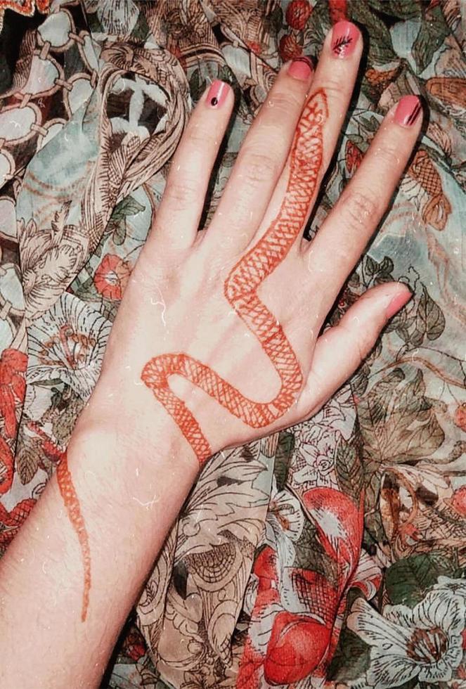 hand with henna tattoo snake photo