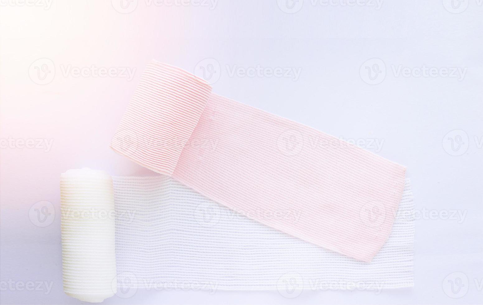 Roll elastic bandage and gauze on white background photo