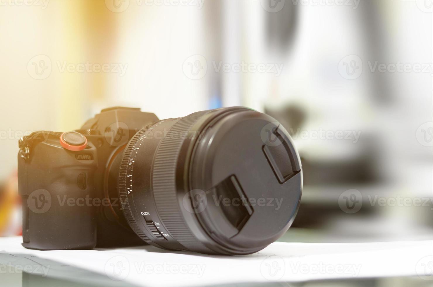 Camerand lens on table on blur background photo