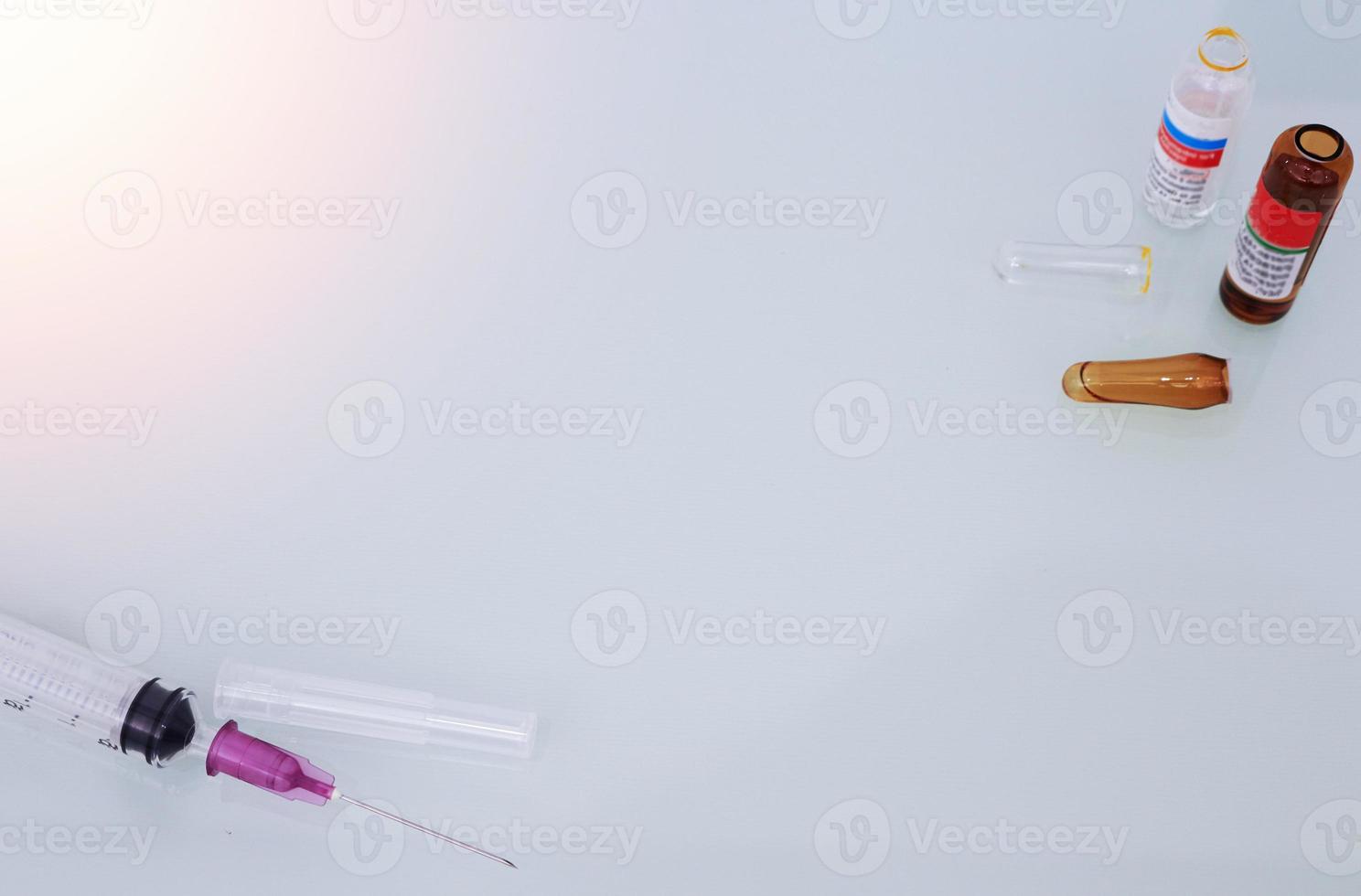 syringe and cracked ampules background photo