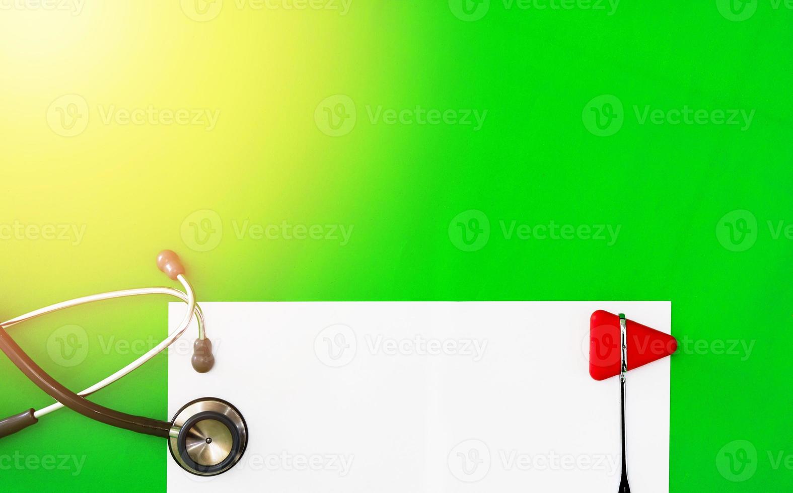 Mock up and doctor jerk hammer,stethoscope on green surgery background in diagnosis and treatment medical healthcare concept with copy space photo