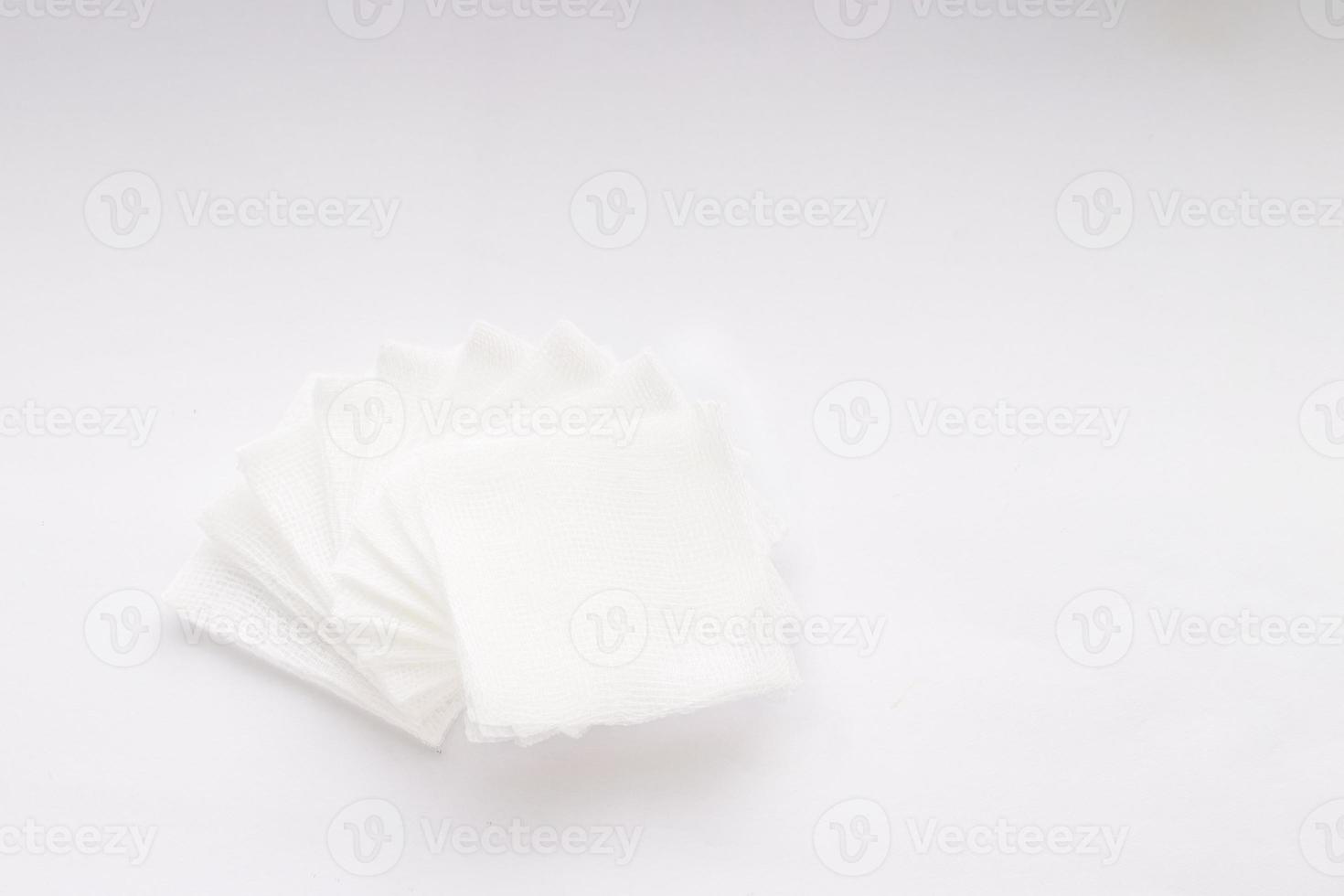 Pile of pad gauzes on white background photo