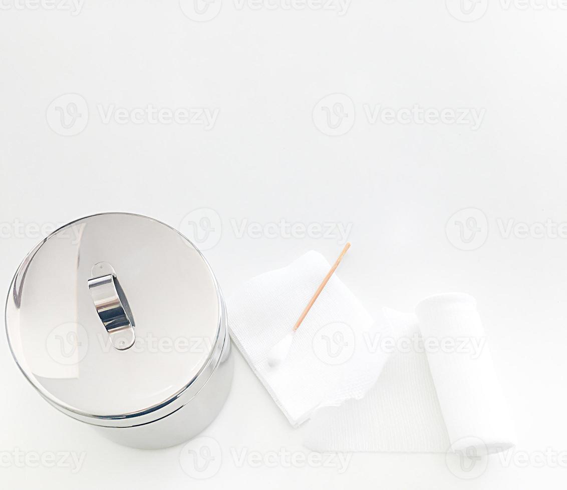 swab ,gauaze ,roll bandage and jar  with copy space in medical concept photo