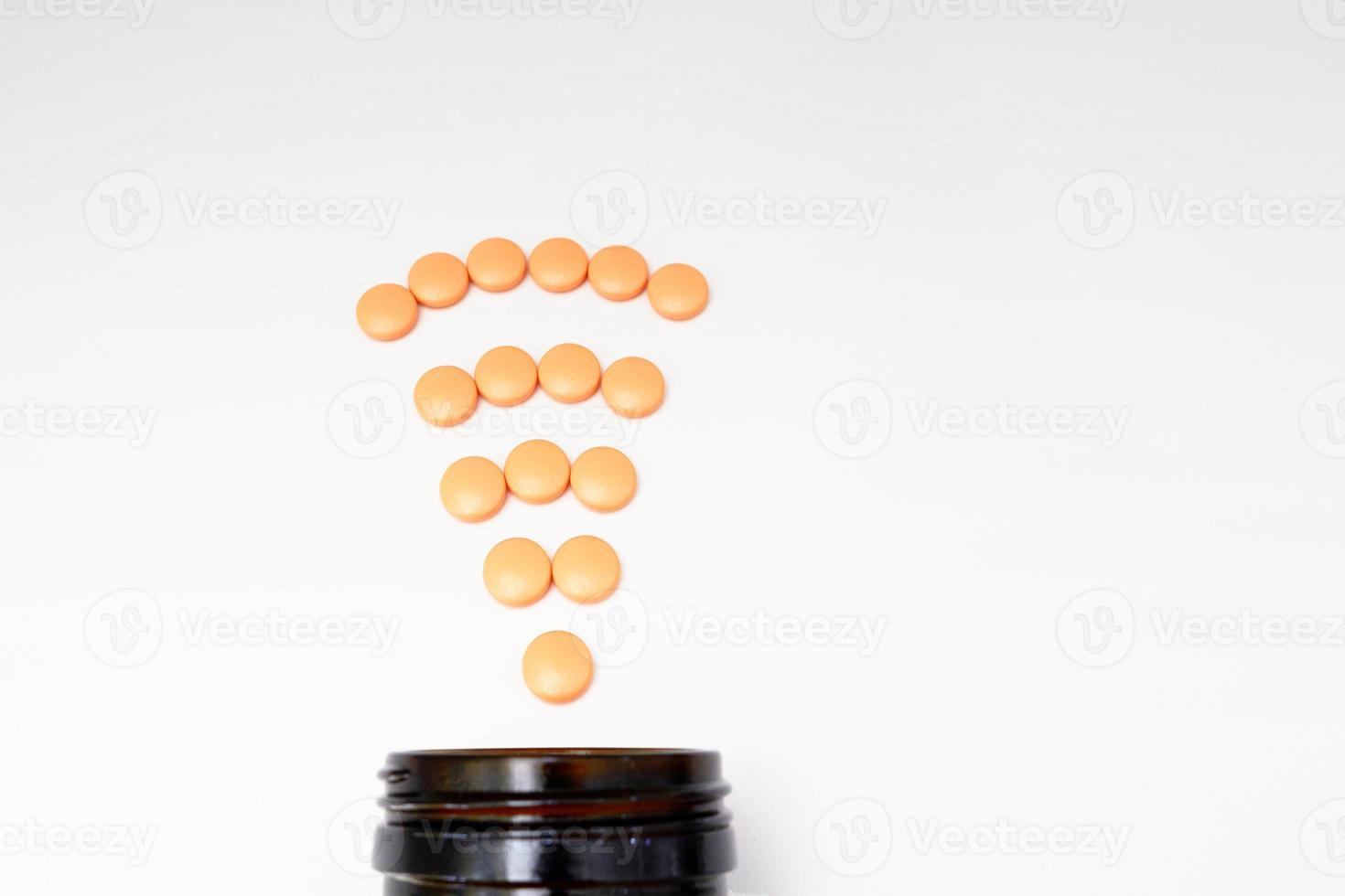 Orange coated round drug tablets on drugstore and bottle in communicated worldwide distribution wifi connected business medical pharmaceutical seller concept photo