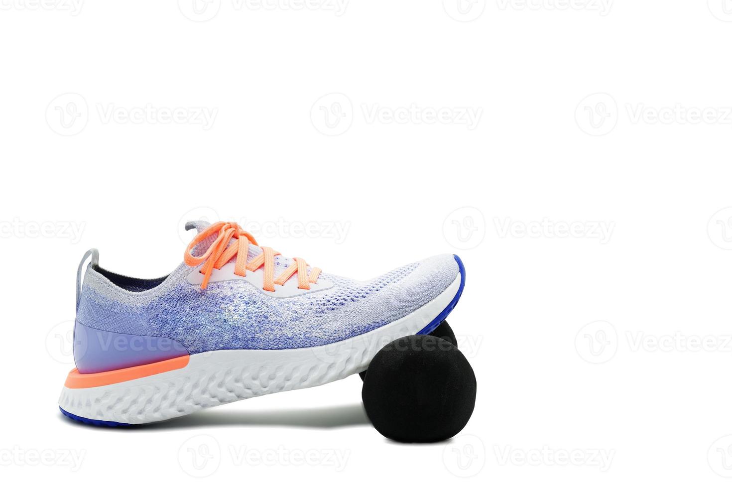 Sport shoe and dumbbell on isolated white background ,side,with copy space photo