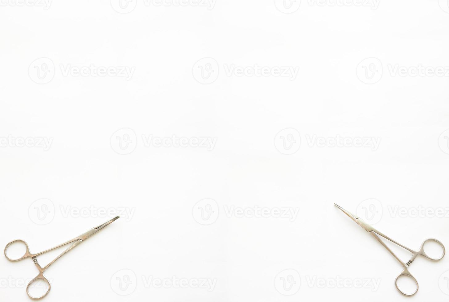cramp forceps on both top corner of white copy space photo