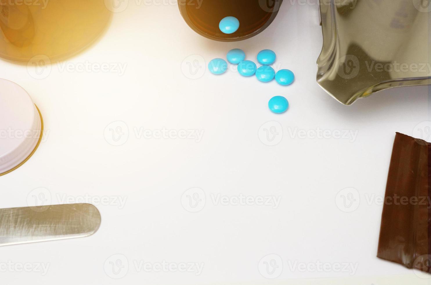 Medical background with blue coated tablets on drug store table counter with copy space photo