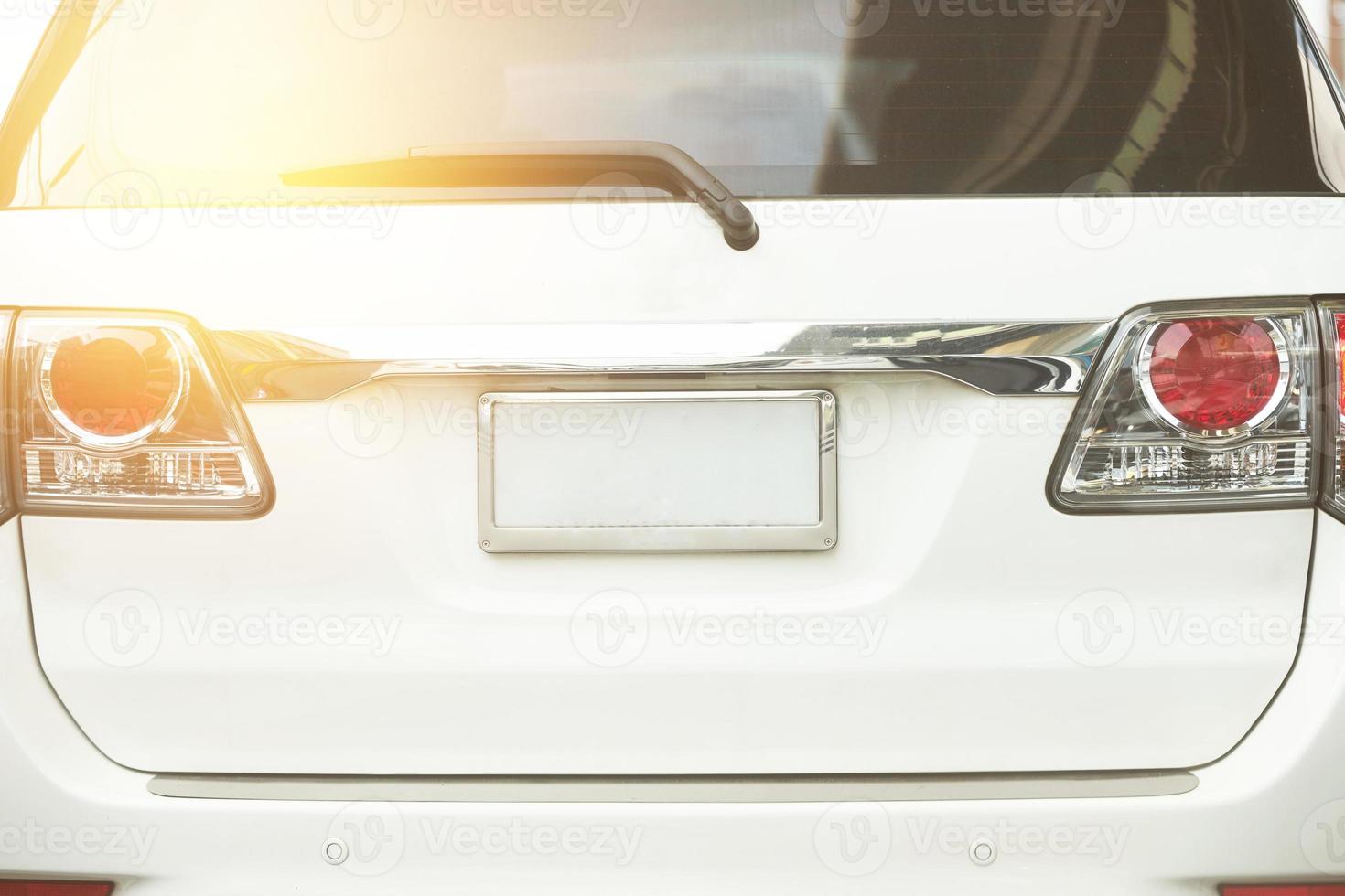 Rear aspect or back view of SUV car in day time on road photo