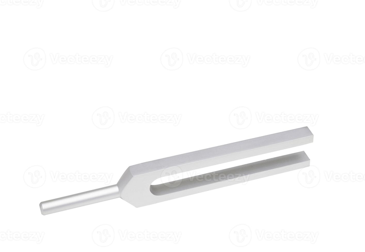 Tuning fork in side up position on isolated white background photo