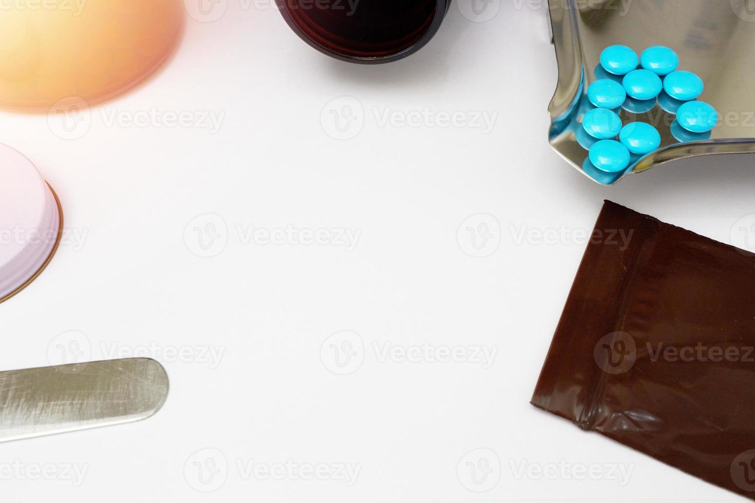 Medical background with blue coated tablets on drugstore table counter with copy space photo