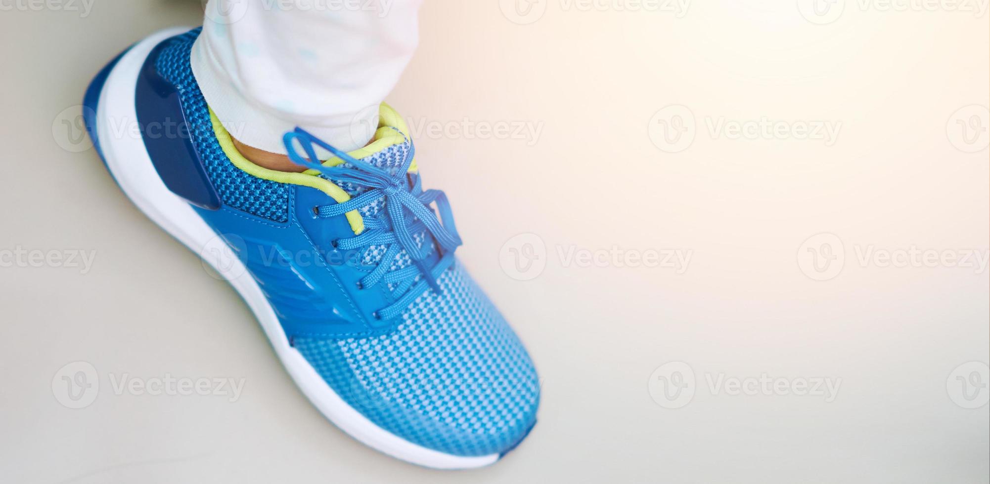 Sport or sneaker blue shoes on wear ing single photo