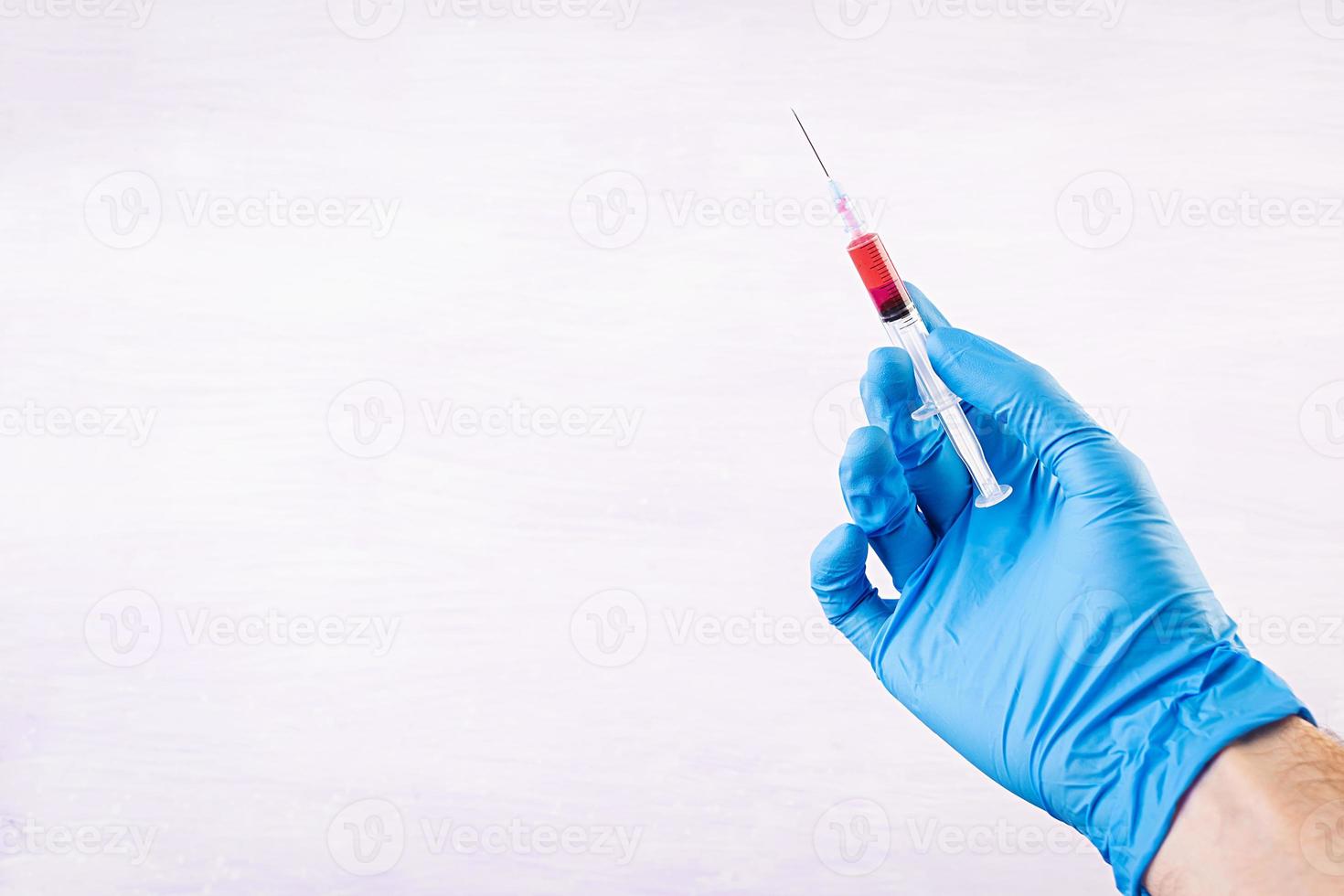 Viral disease protection. Disease and epidemic prevention. Syringe in hands photo