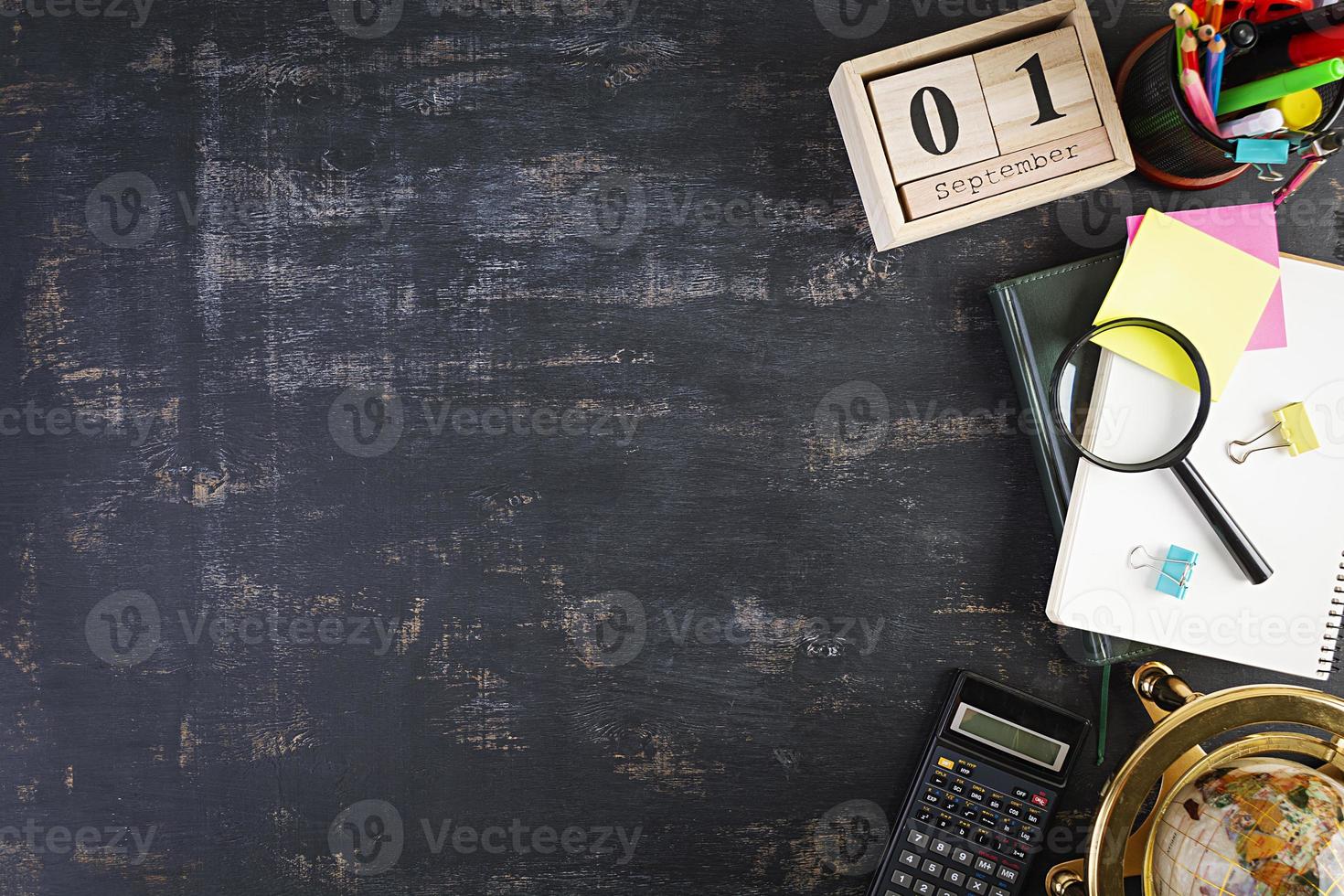 Different school supplies on dark background. Concept Back to school photo