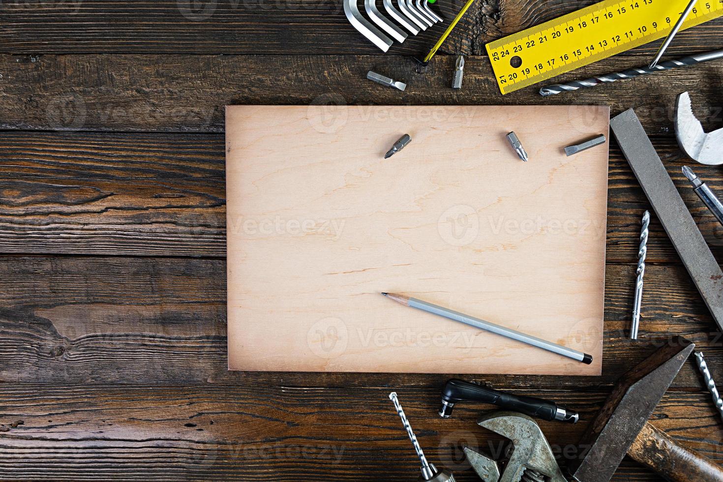 Set of working tools on wooden rustic background. Top view. Copy space photo