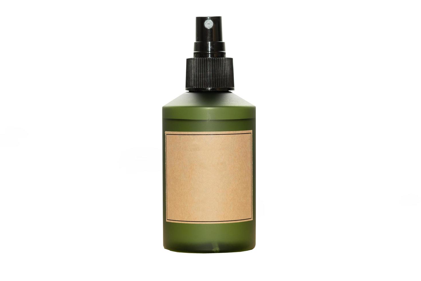 Green cosmetic bottle with label isolated on white background. Close up aroma spray bottle. Concept of organic cruelty free. Natural organic spa cosmetics concept. photo