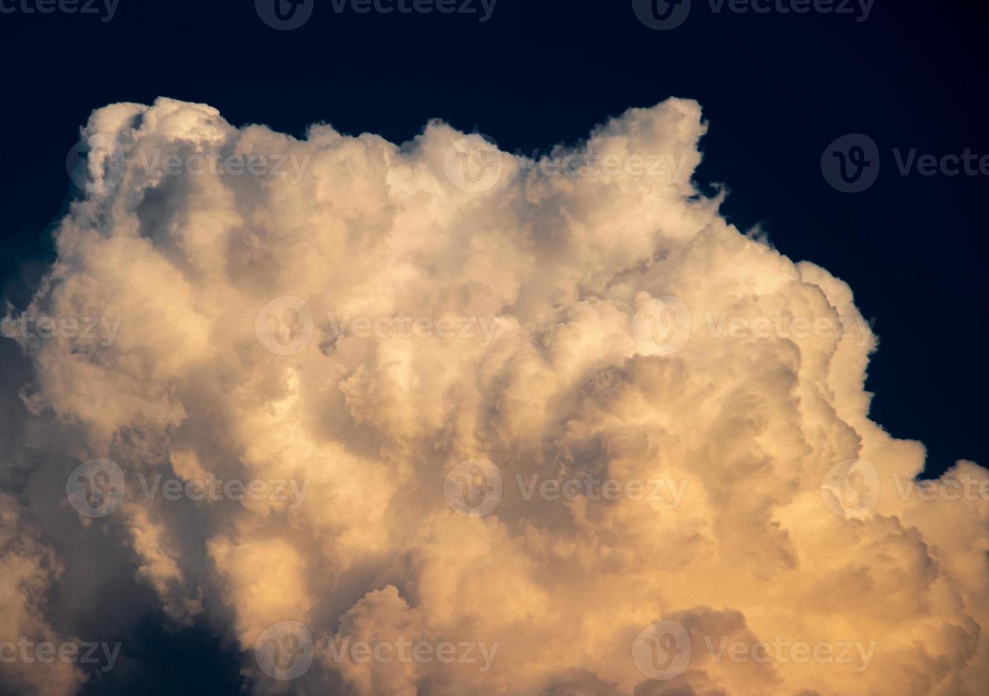 White cumulus clouds reflect the evening sunlight on a blue background, more than the space of an image, Natural abstract. photo