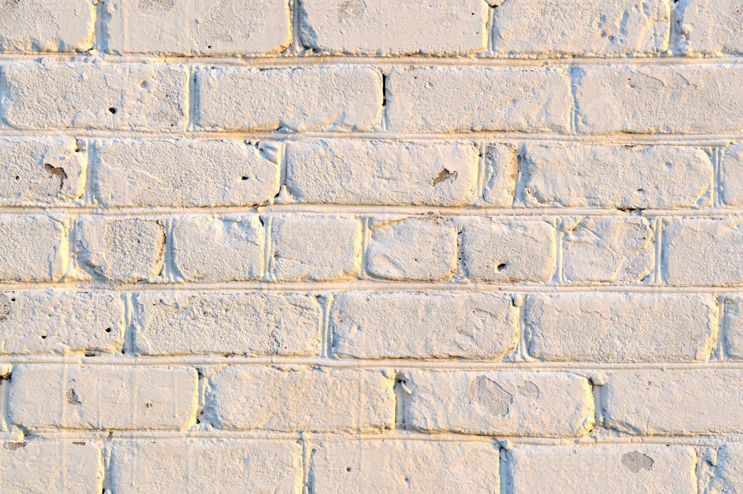 Old white brick wall. Ancient stone texture background. Urban background, white ruined industrial brick wall with copy space. Home and office design backdrop. Vintage effect photo
