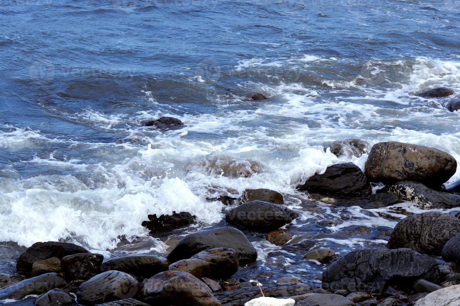 Beautiful romantic photo, seashore on the beach. Relaxing seascape. Waves with foam on the sea. Summer sunny day. Vacation spirit. Beautiful landscape. Nature background photo