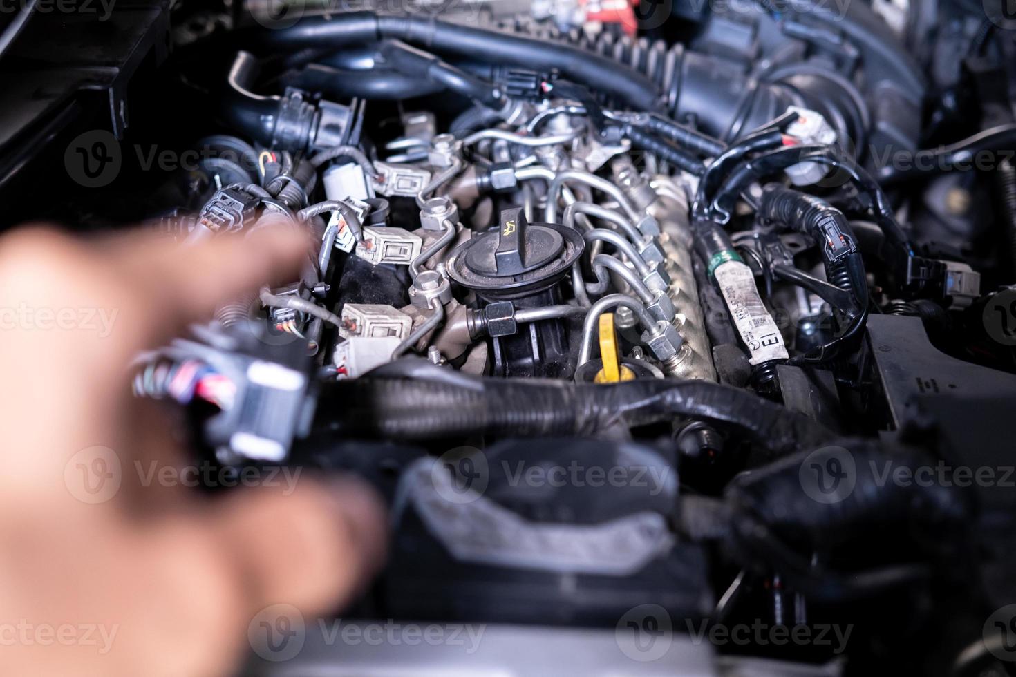 Engine car service mechanic maintenance inspection service maintenance car Check engine oil level car in garage showroom dealership blurred background. photo