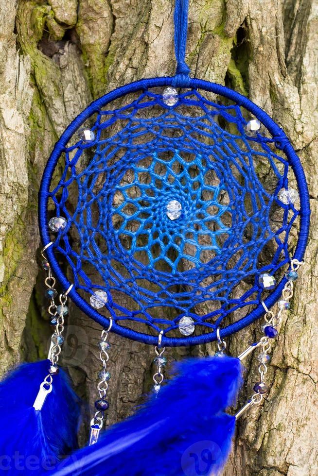 Handmade dream catcher with feathers threads and beads rope hanging photo