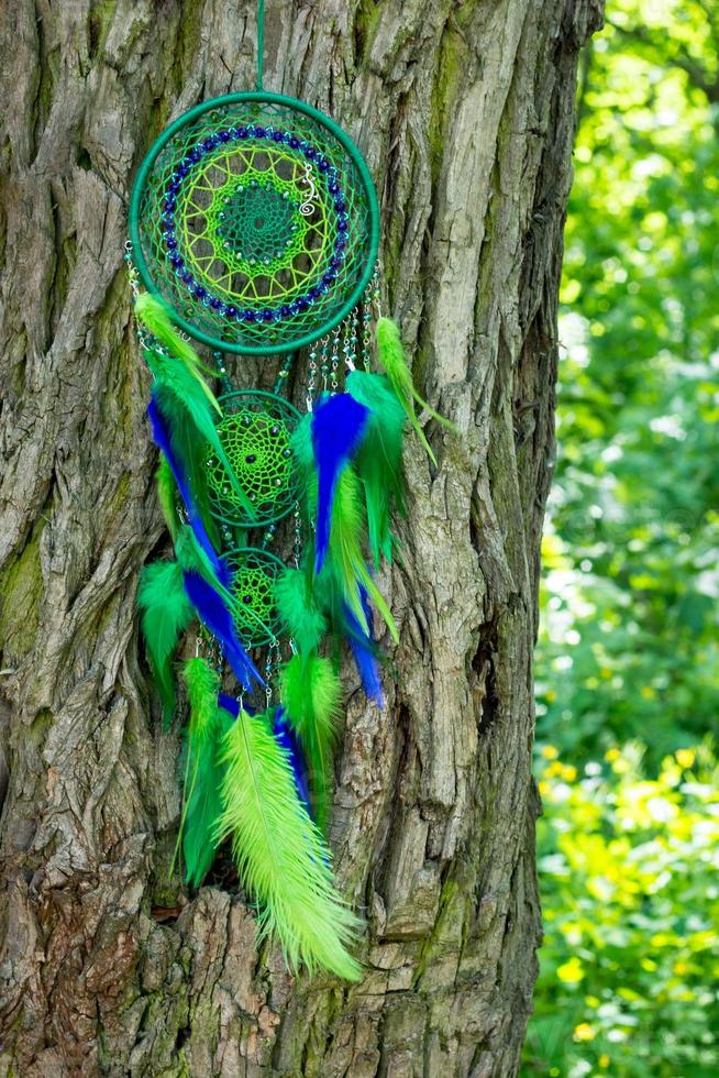 Handmade dream catcher with feathers threads and beads rope hanging photo