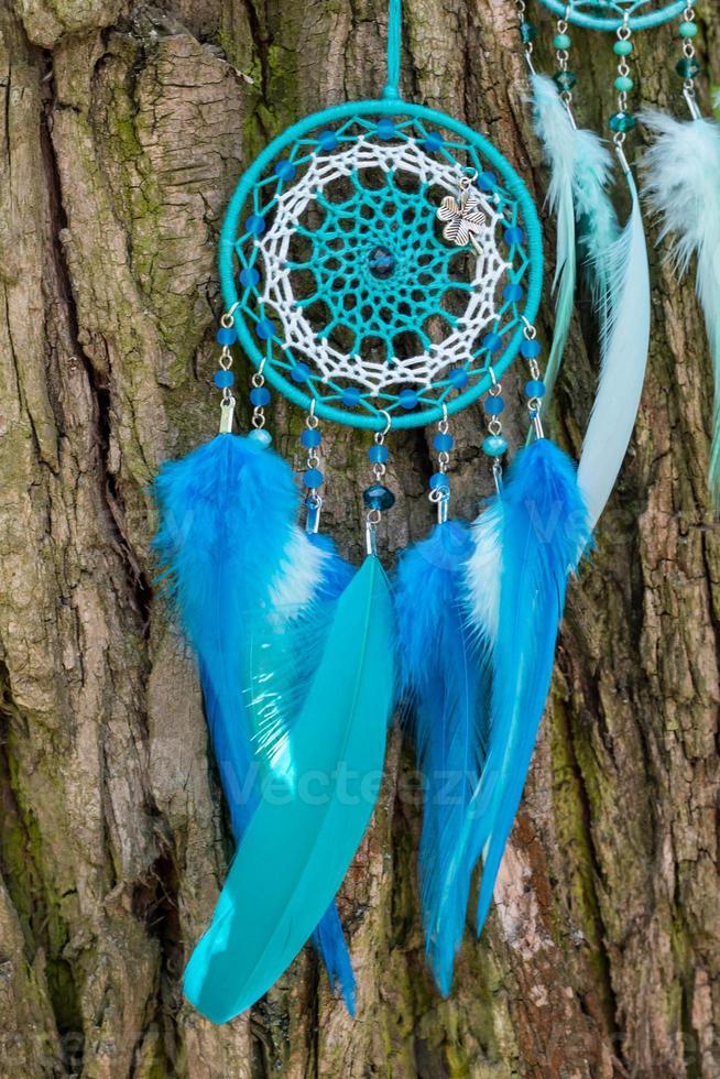 Handmade dream catcher with feathers threads and beads rope hanging photo