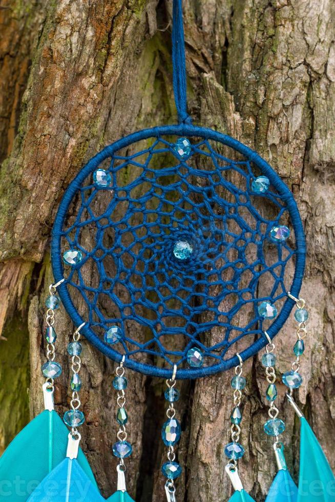 Handmade dream catcher with feathers threads and beads rope hanging photo