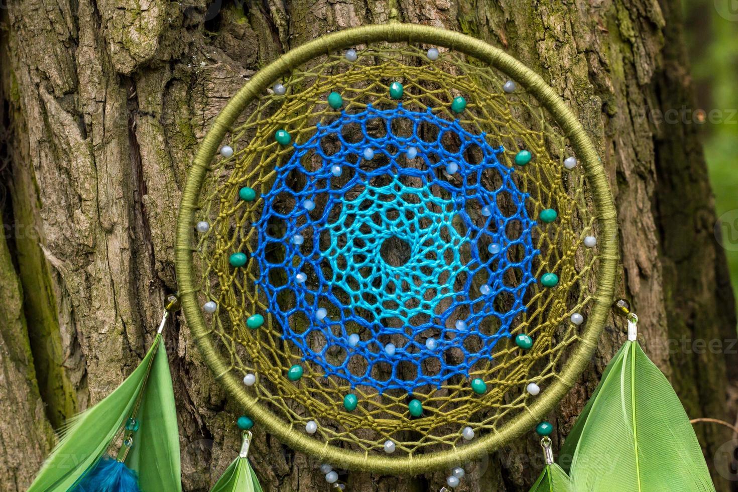 Handmade dream catcher with feathers threads and beads rope hanging photo