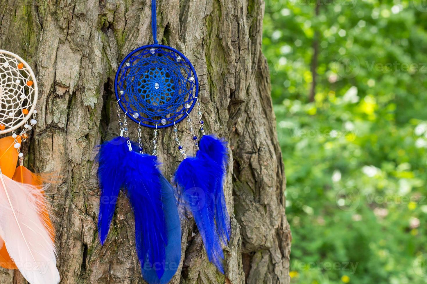 Handmade dream catcher with feathers threads and beads rope hanging photo
