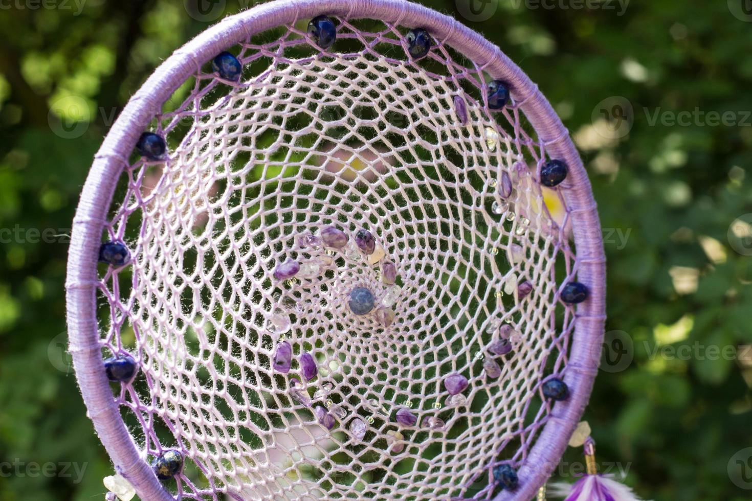 Handmade dream catcher with feathers threads and beads rope hanging photo
