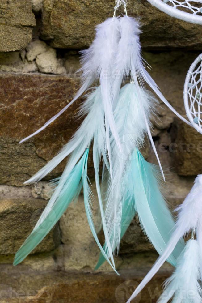 Handmade dream catcher with feathers threads and beads rope hanging photo
