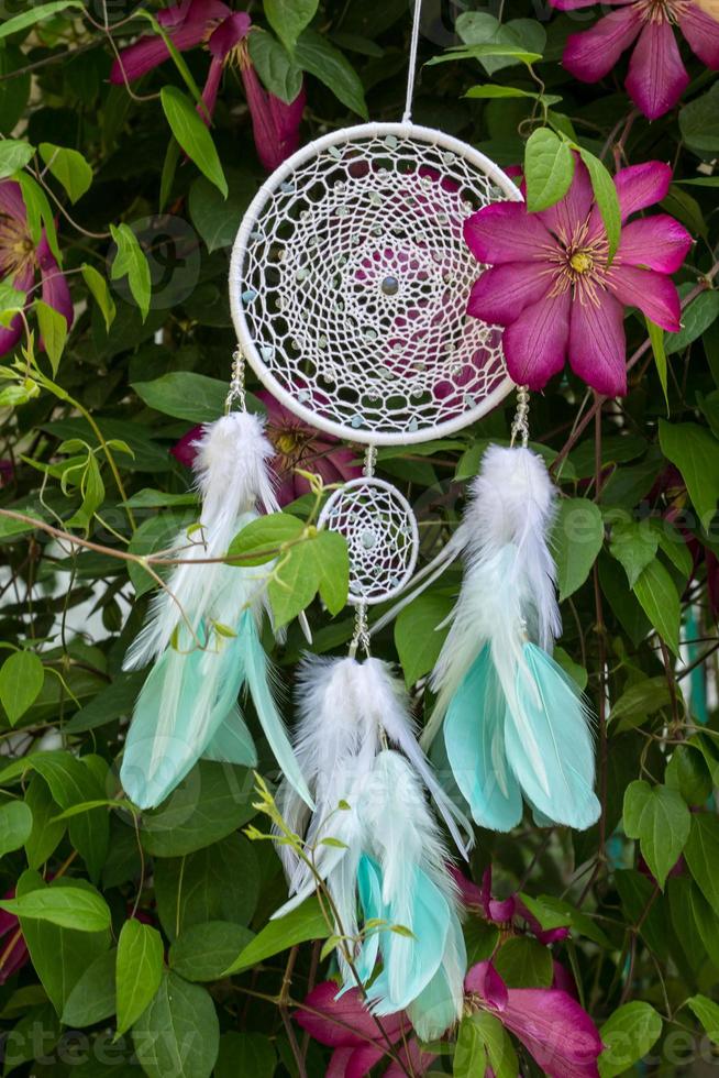 Handmade dream catcher with feathers threads and beads rope hanging photo