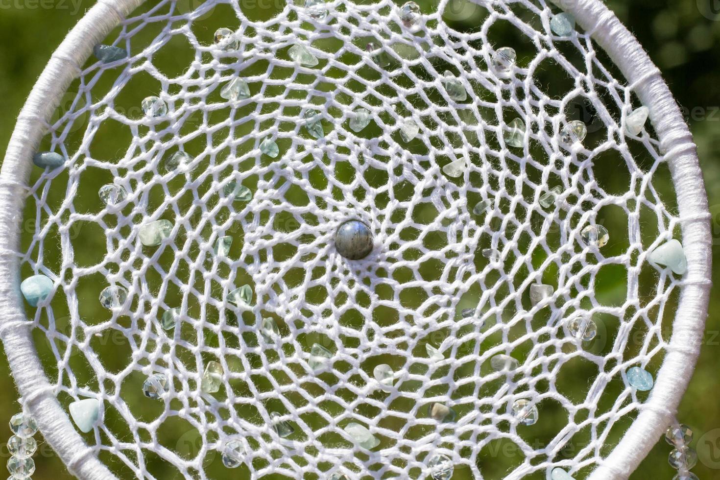 Handmade dream catcher with feathers threads and beads rope hanging photo