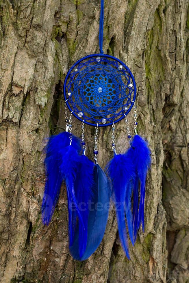 Handmade dream catcher with feathers threads and beads rope hanging photo