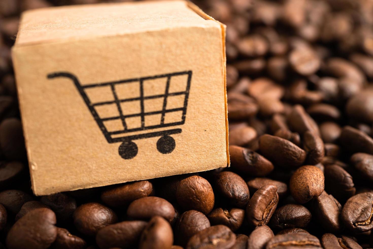 Box with shopping cart logo symbol on coffee beans, Import Export Shopping online or eCommerce delivery service store product shipping, trade, supplier concept. photo