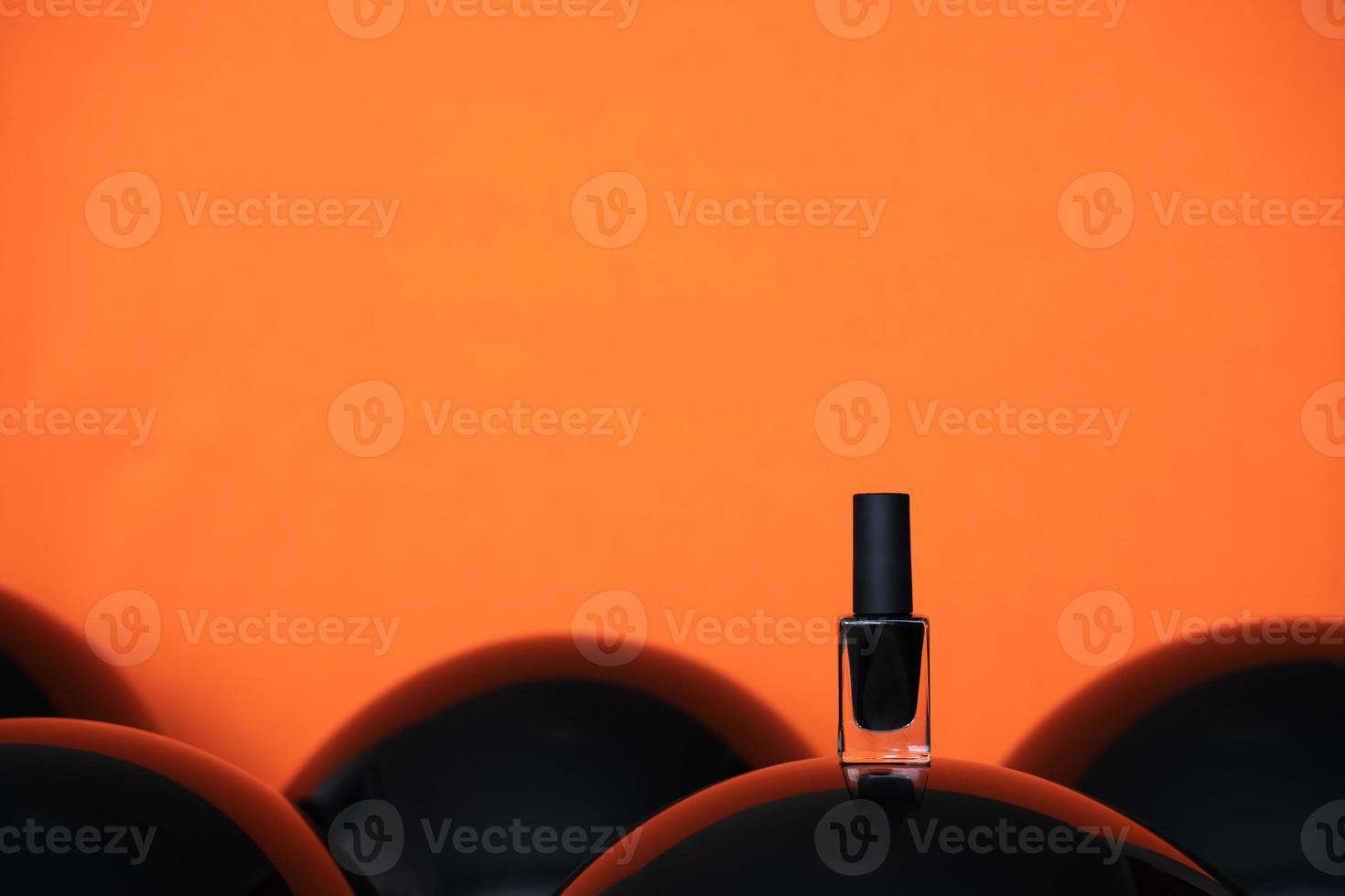 black nail polish on balloon orange background photo