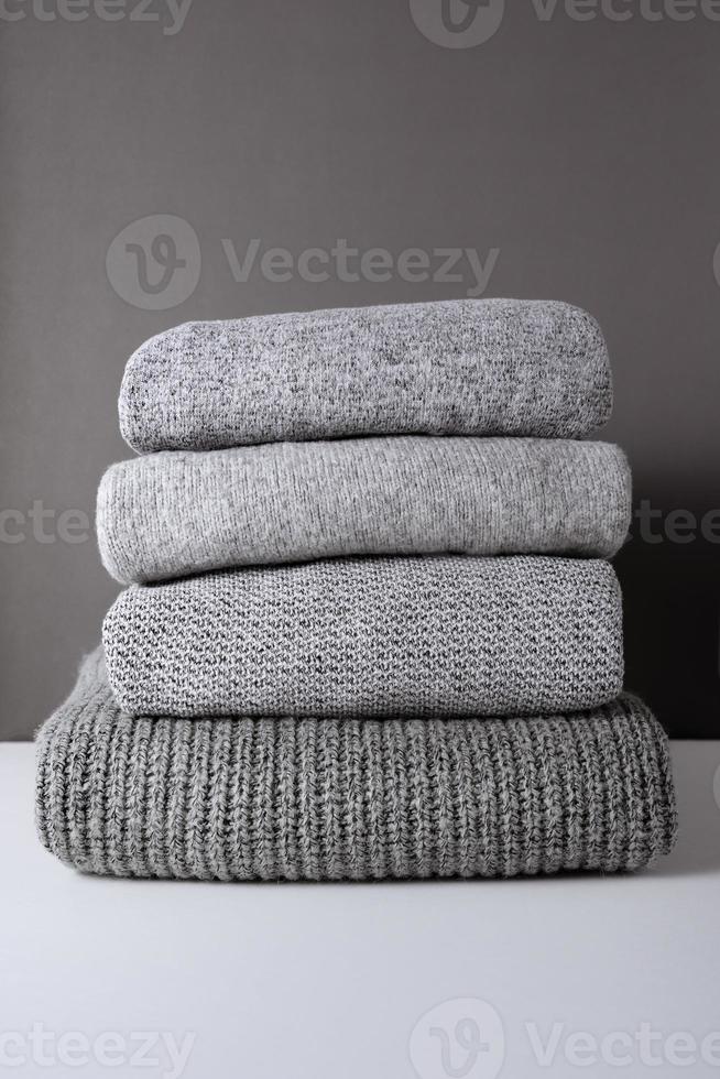 stack of grey knit sweaters photo