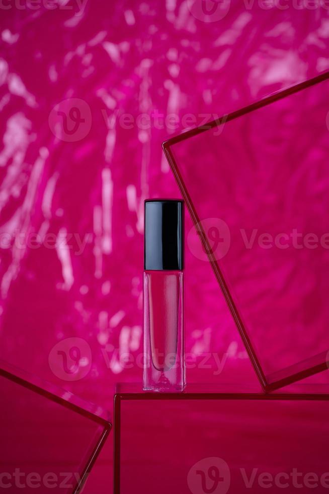 Hot pink nail polish on bright pink background photo