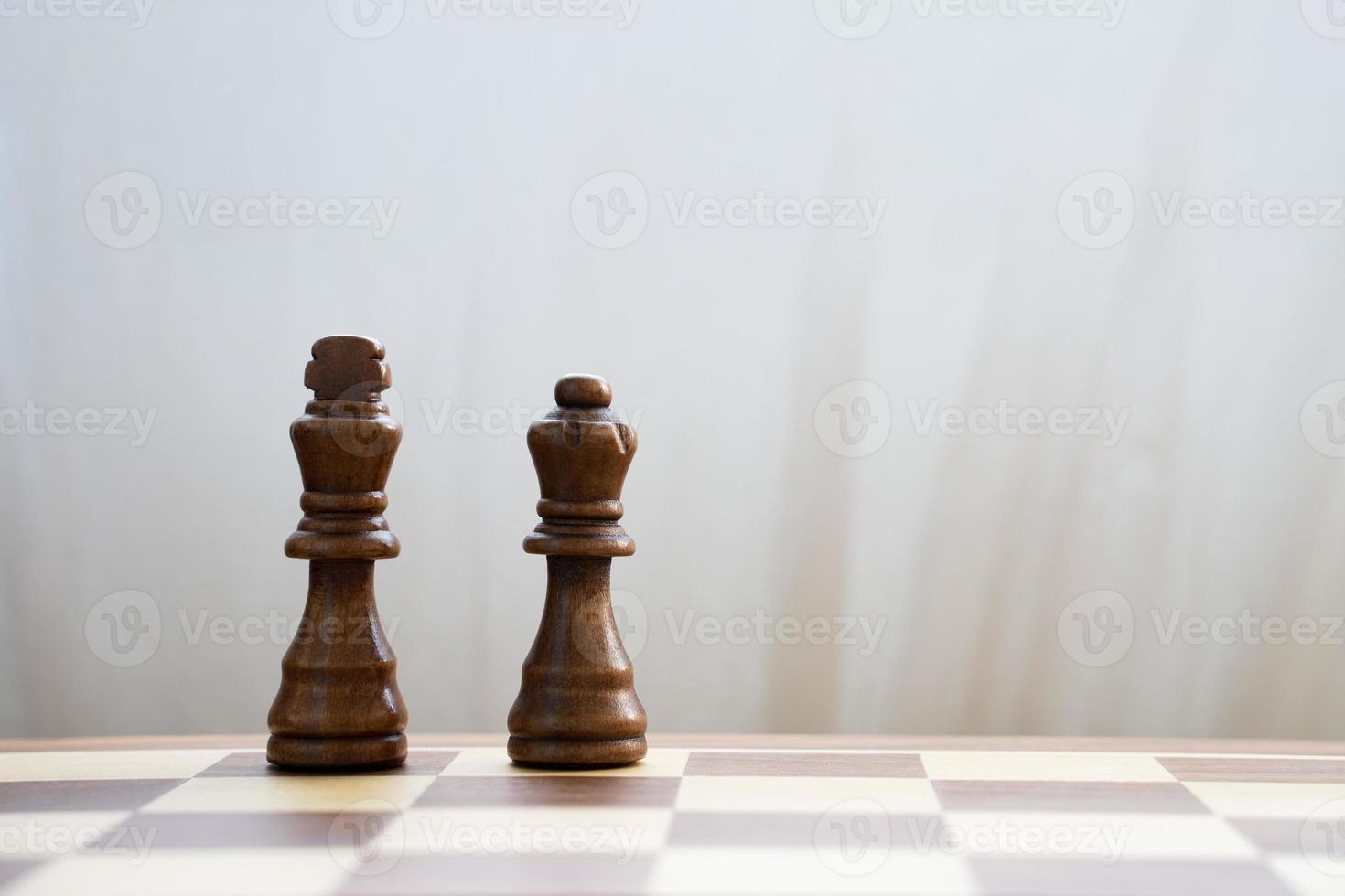 Black king and queen on chess board photo