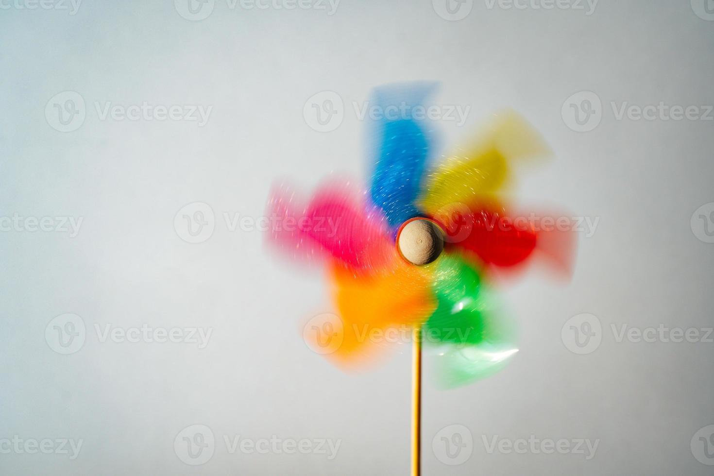 Colorful turning pinwheel homemade on white background photo