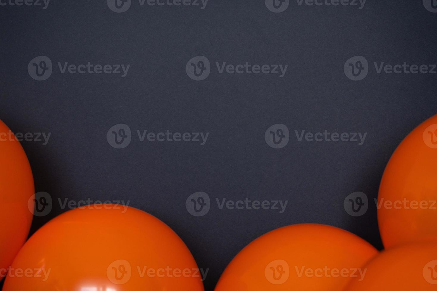 simple orange balloons on black background photo