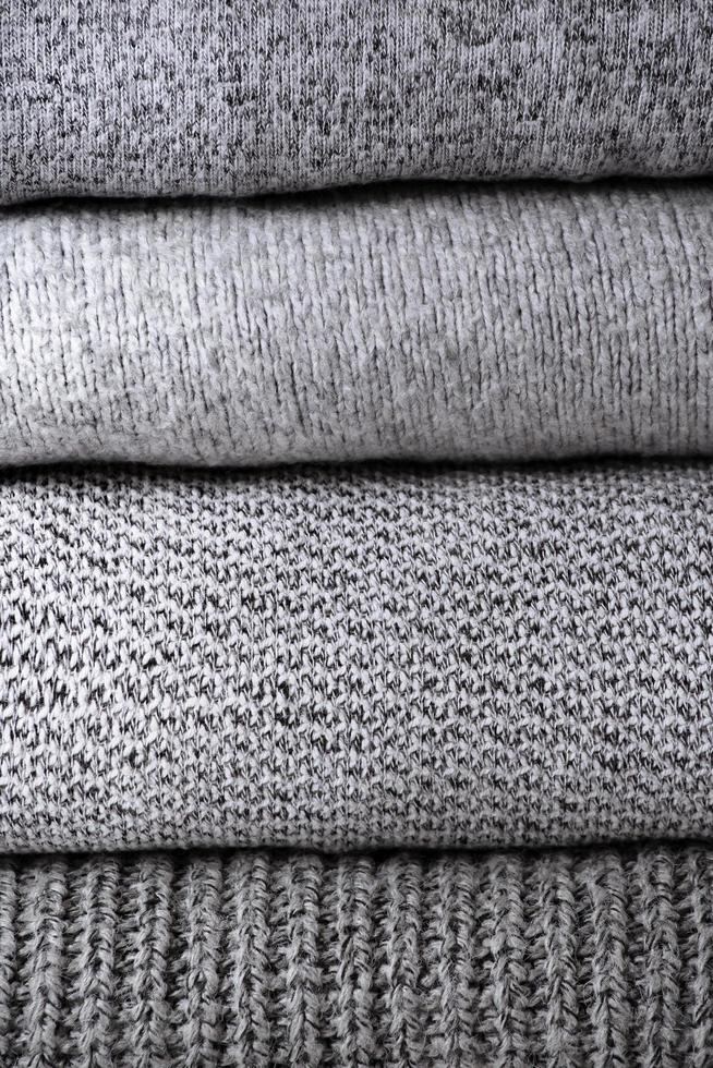 stack of grey knit sweaters photo