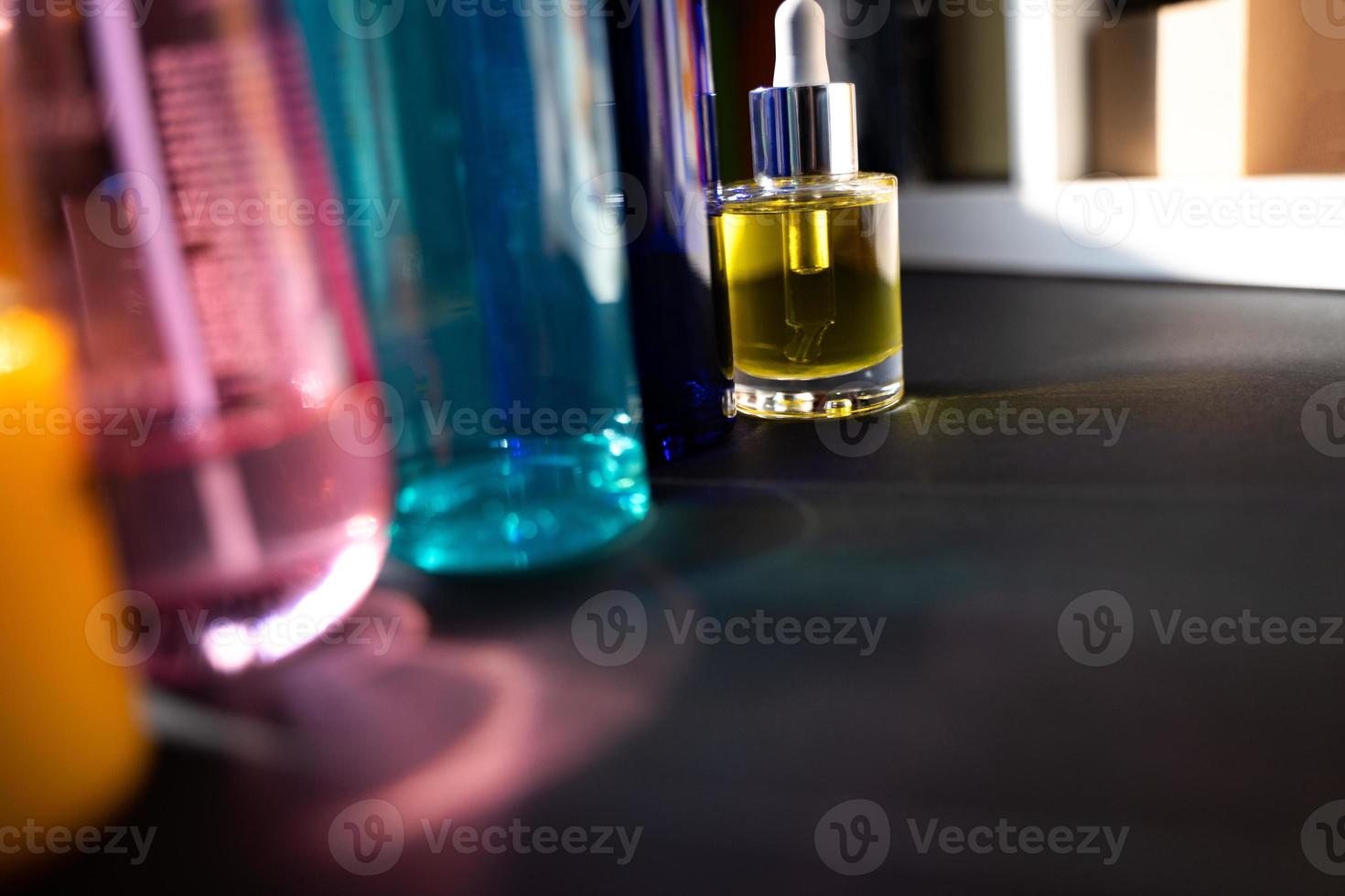 Multicolor glass bottles and reflections in harsh light photo